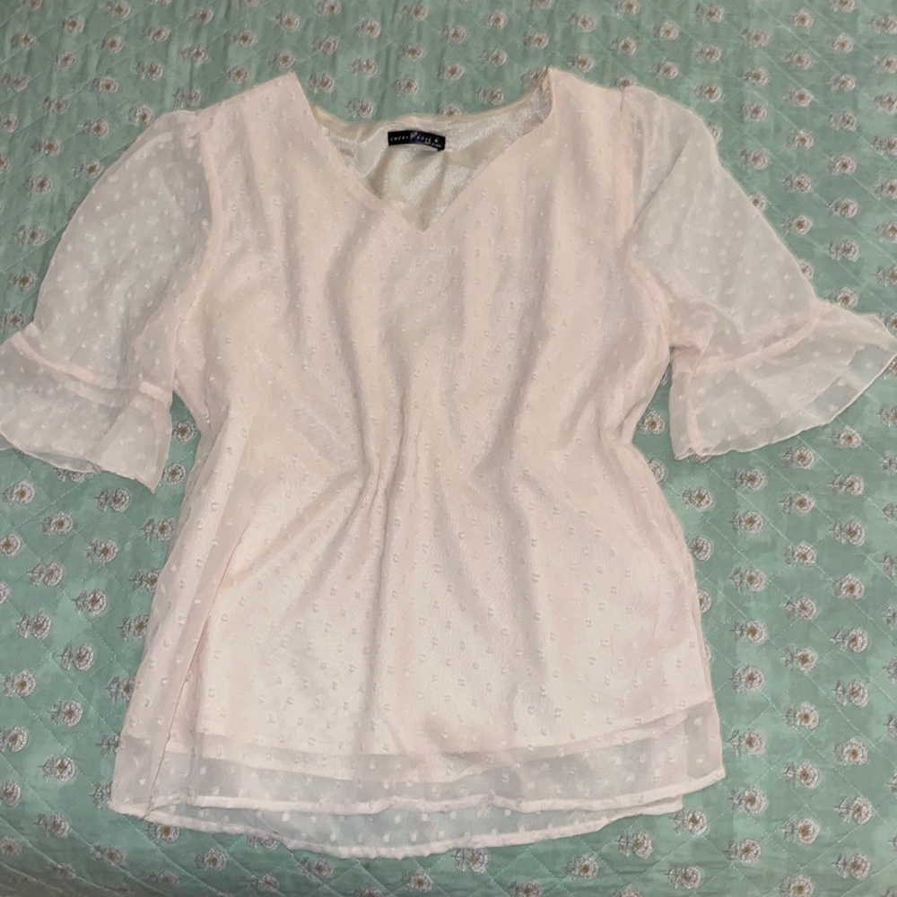 Cream blouse with sheer dots.